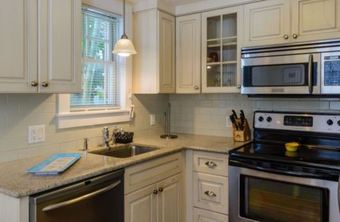 Kitchen with white cabinetry, quartz countertop, and stainless steel dishwasher, microwave, stove, and refridgerator